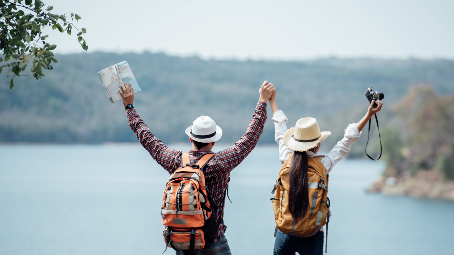 Couple family traveling together,Tourist couple Backpack along mountains and coast, freedom and active lifestyle concept